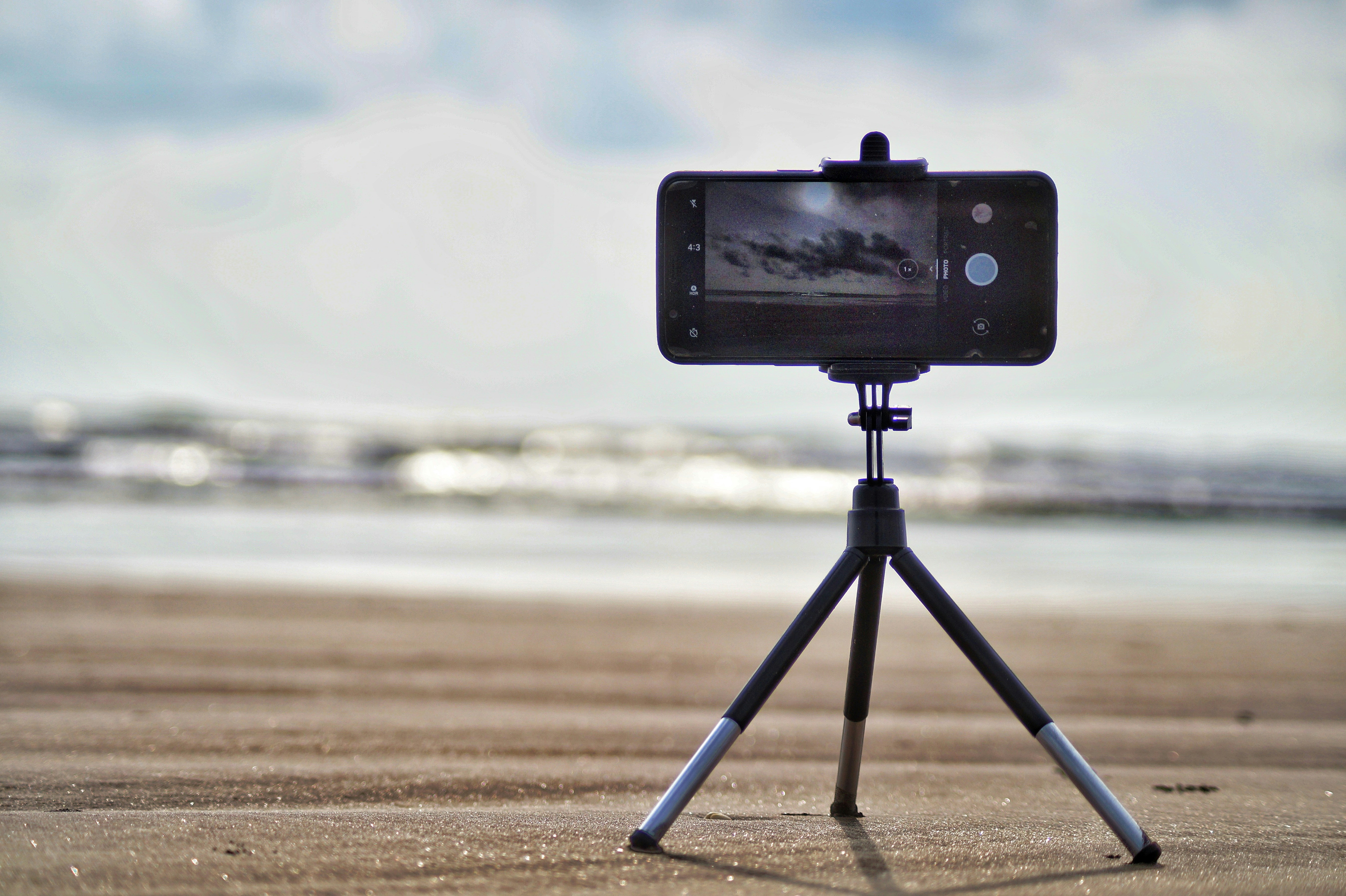 Smartphone mounted on a small tripod ready to shoot